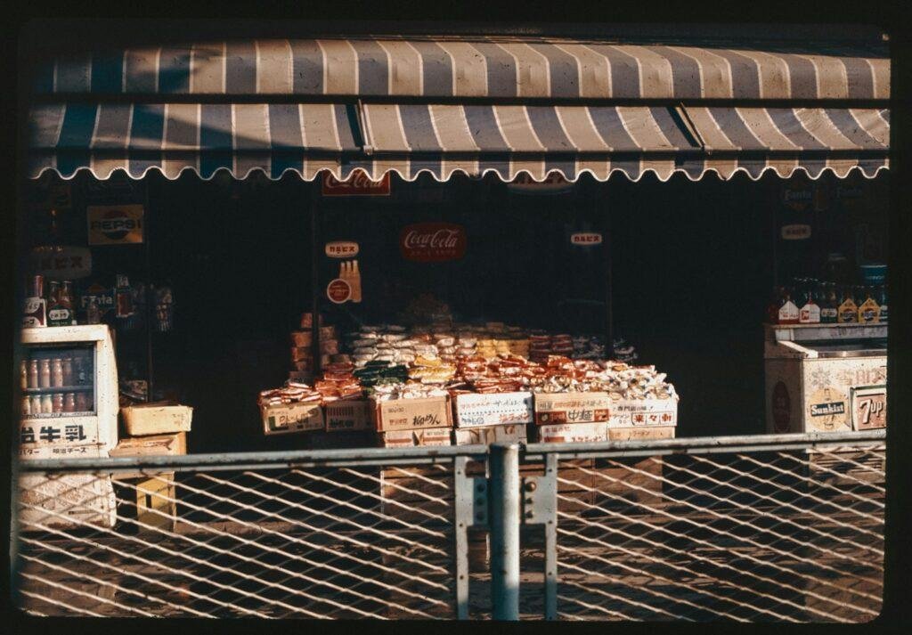 A food stand with a striped awning over it